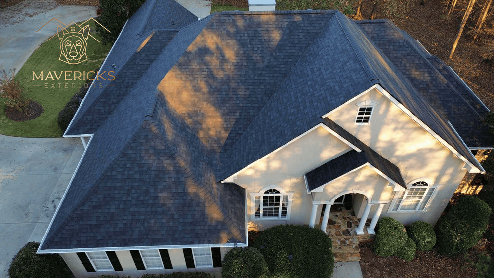 Aerial view of a home with a new dark shingle roof