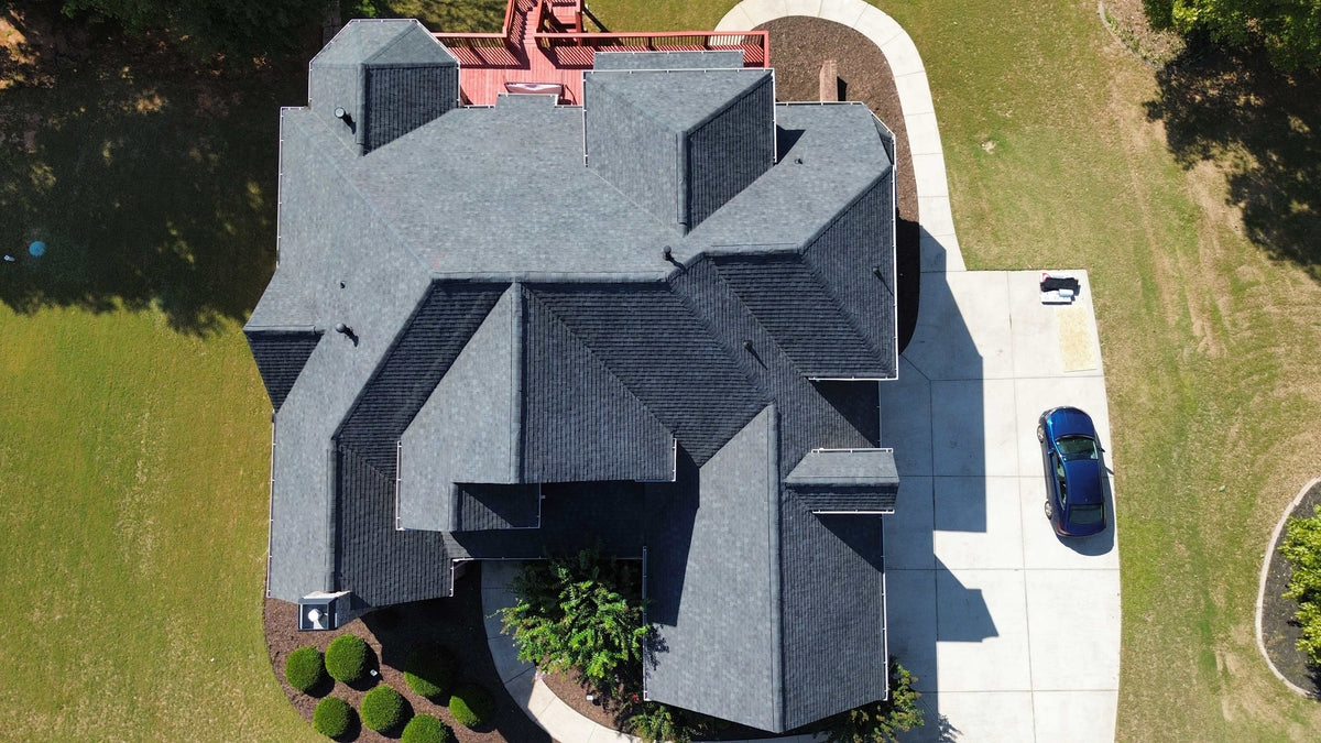 Overhead drone view of a new dark gray shingle roof